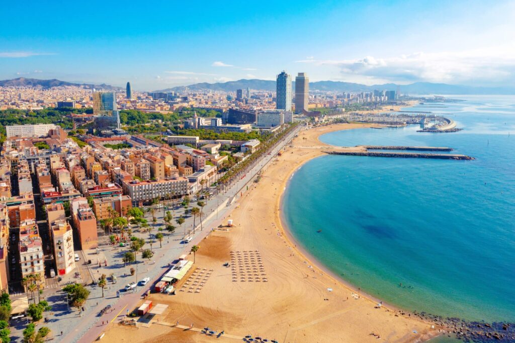 Panoramic view of Barcelona’s skyline, featuring historic landmarks and Mediterranean coast.