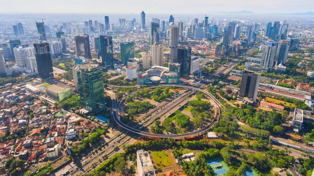 Jakarta’s cityscape featuring a blend of modern buildings and traditional markets.